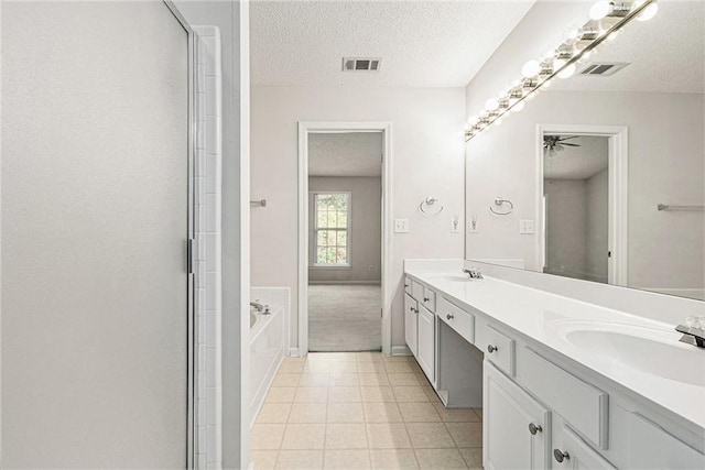 bathroom with a textured ceiling, visible vents, and a sink