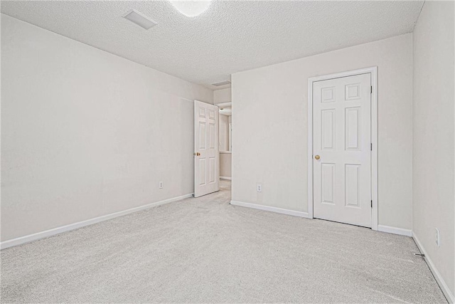 unfurnished bedroom featuring baseboards, carpet floors, and a textured ceiling