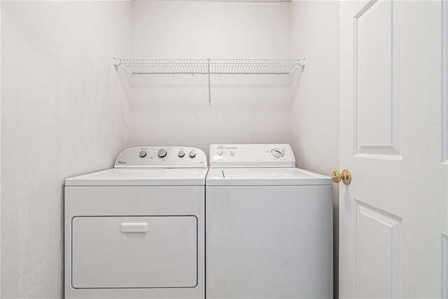 clothes washing area with laundry area and independent washer and dryer