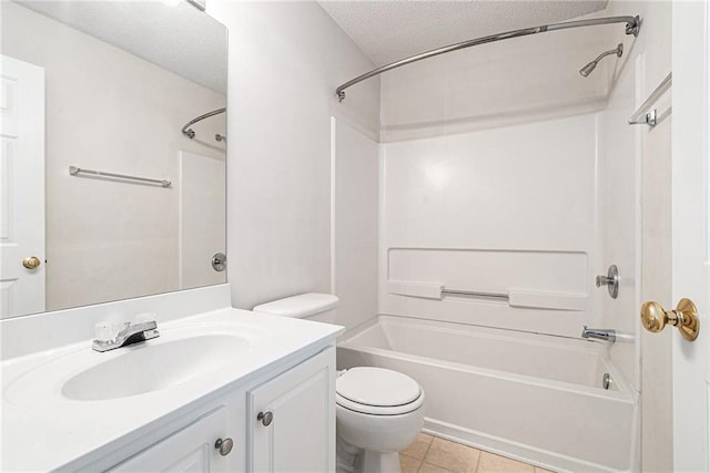 bathroom with tile patterned floors, toilet, a textured ceiling,  shower combination, and vanity