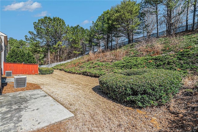 view of yard with fence and central AC