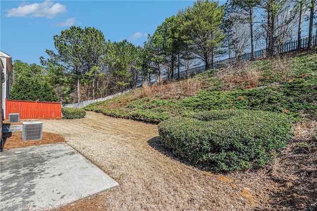 view of yard featuring central air condition unit and fence
