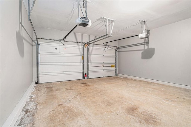 garage with baseboards and a garage door opener