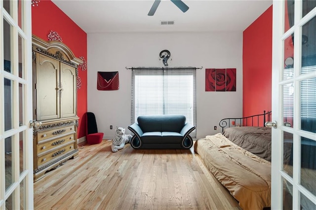 1227 Castle Point Ct SW, Conyers, GA 30094 - bedroom featuring wood finished floors, multiple windows, french doors, and a ceiling fan