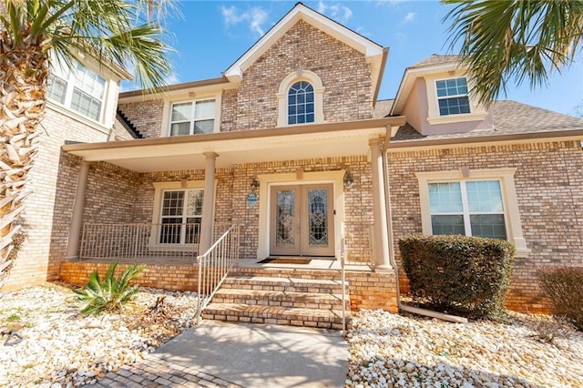 1227 Castle Point Ct SW, Conyers, GA 30094 - view of front facade with brick siding, a porch, and french doors