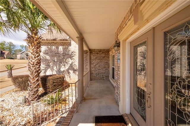 1227 Castle Point Ct SW, Conyers, GA 30094 - view of exterior entry with a porch and brick siding