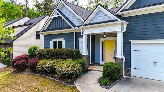 view of front facade featuring board and batten siding, an attached garage, a shingled roof, and covered porch