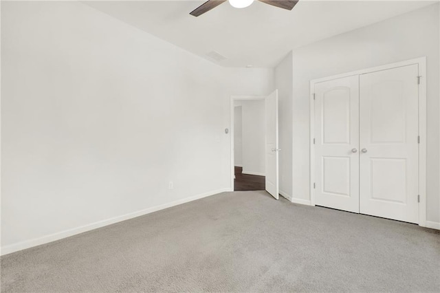 unfurnished bedroom with visible vents, carpet floors, a closet, baseboards, and ceiling fan