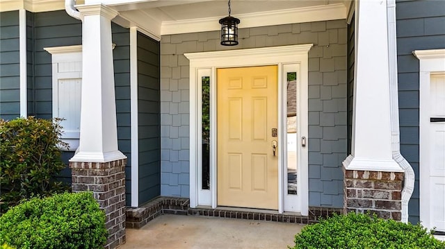 view of exterior entry with covered porch