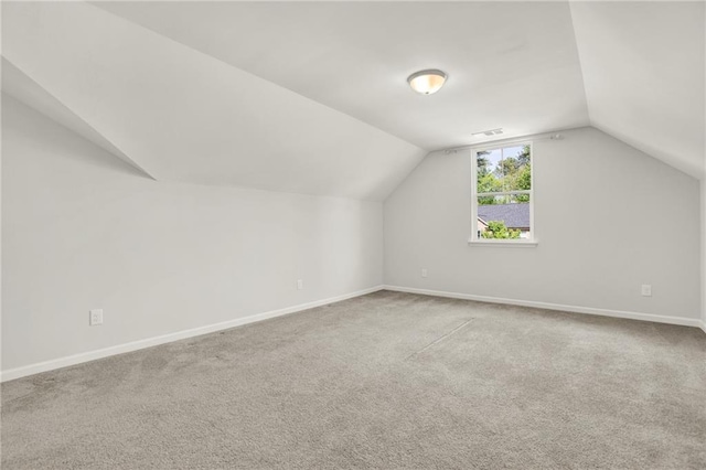 bonus room with lofted ceiling, visible vents, carpet floors, and baseboards