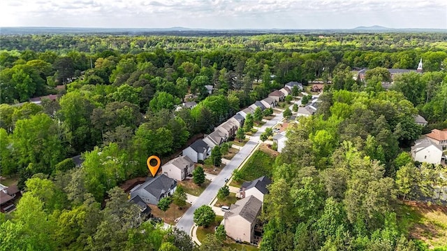 drone / aerial view featuring a view of trees and a residential view