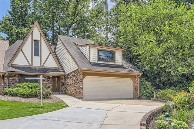 12 Westchester Sq, Decatur, GA 30030 - view of front facade featuring brick siding, driveway, and an attached garage