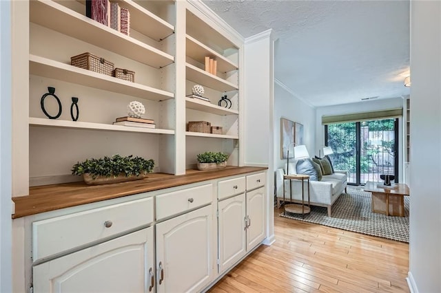 12 Westchester Sq, Decatur, GA 30030 - detailed view of wood finished floors, crown molding, and a textured ceiling