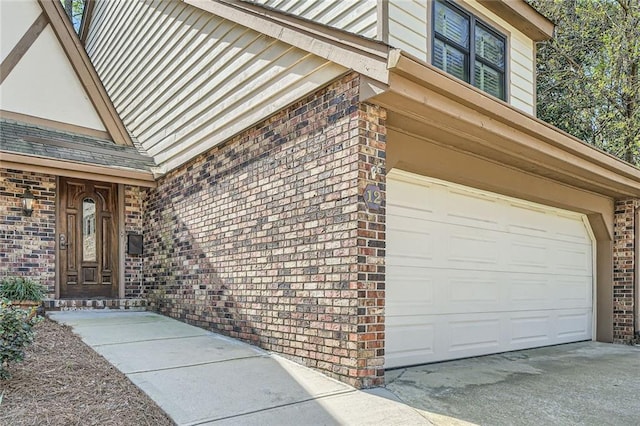 12 Westchester Sq, Decatur, GA 30030 - view of exterior entry with brick siding, a garage, and concrete driveway