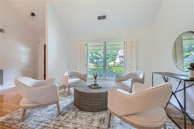 12 Westchester Sq, Decatur, GA 30030 - living area featuring vaulted ceiling, wood finished floors, and healthy amount of natural light