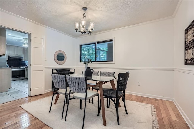 12 Westchester Sq, Decatur, GA 30030 - dining area featuring light wood-type flooring, a chandelier, crown molding, and a textured ceiling
