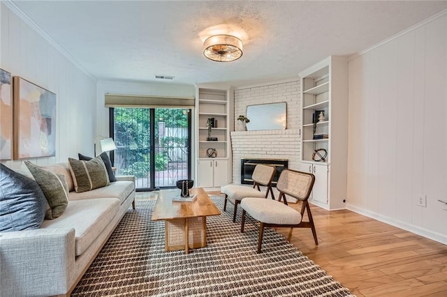 12 Westchester Sq, Decatur, GA 30030 - living area featuring light wood-style flooring, a fireplace, crown molding, and built in features