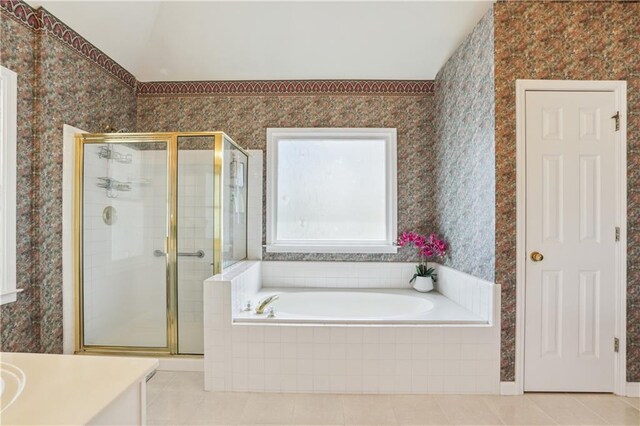 full bath with a garden tub, tile patterned flooring, vanity, a shower stall, and wallpapered walls