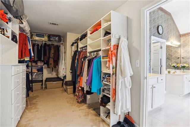 spacious closet with visible vents and light colored carpet