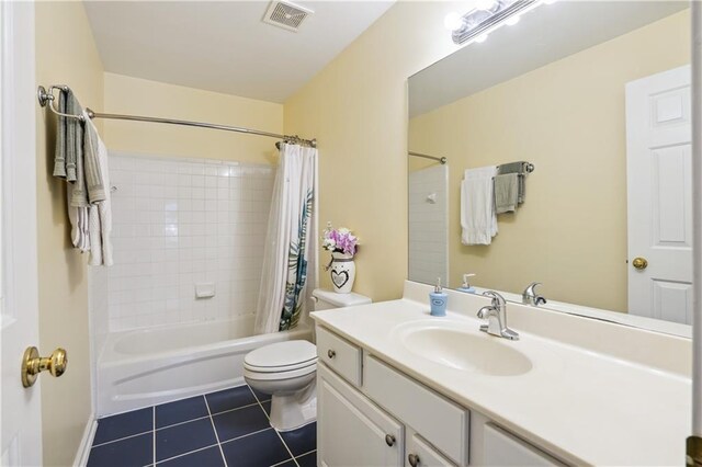 bathroom featuring shower / tub combo with curtain, visible vents, toilet, vanity, and tile patterned flooring