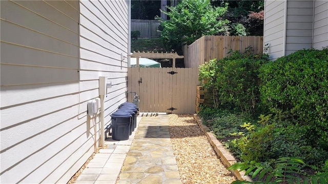 view of patio with fence and a gate