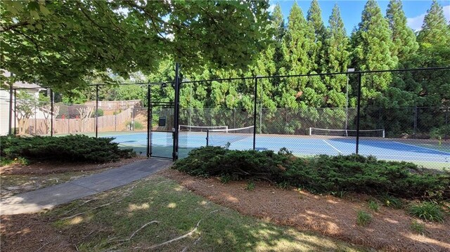 view of sport court featuring fence