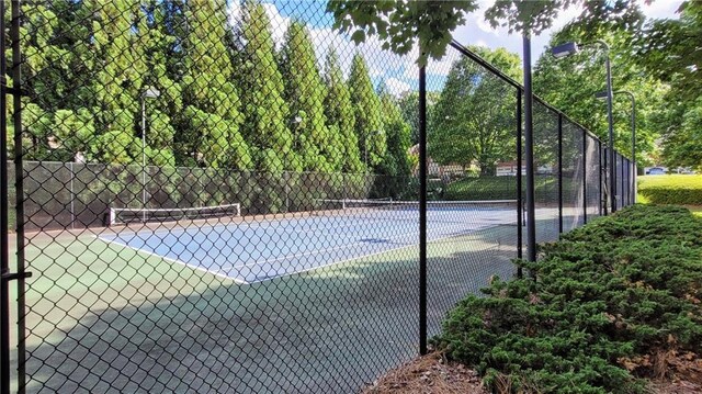 view of sport court featuring fence