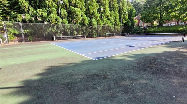 view of sport court with fence