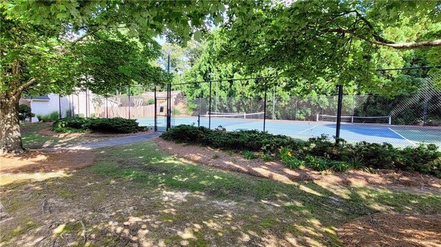 view of tennis court with fence