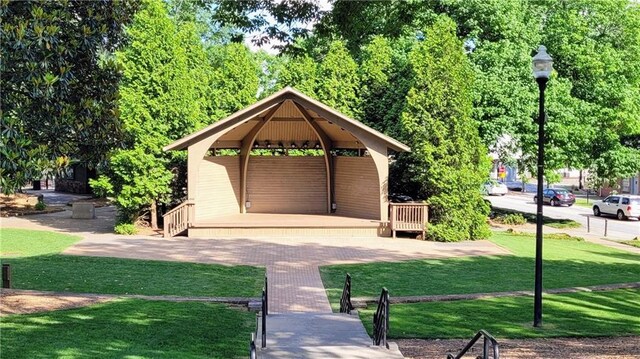 surrounding community with a lawn and a gazebo