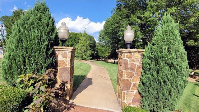 view of gate featuring a yard