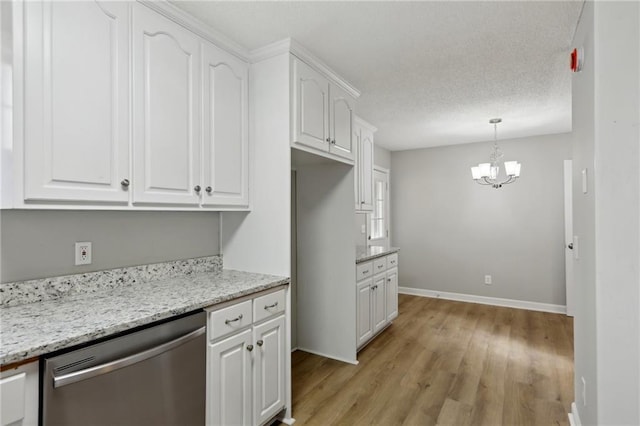 kitchen with a textured ceiling, a notable chandelier, white cabinetry, stainless steel dishwasher, and light wood finished floors