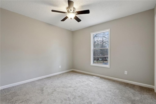 unfurnished room with carpet floors, a textured ceiling, and baseboards