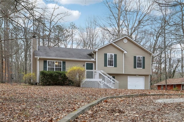 split level home with a garage and a chimney