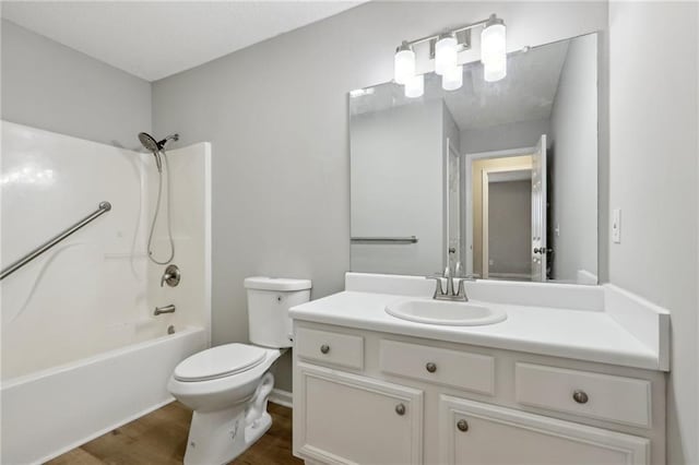 bathroom with bathtub / shower combination, vanity, toilet, and wood finished floors