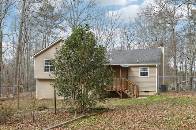 back of house featuring a shingled roof, crawl space, fence, and a chimney