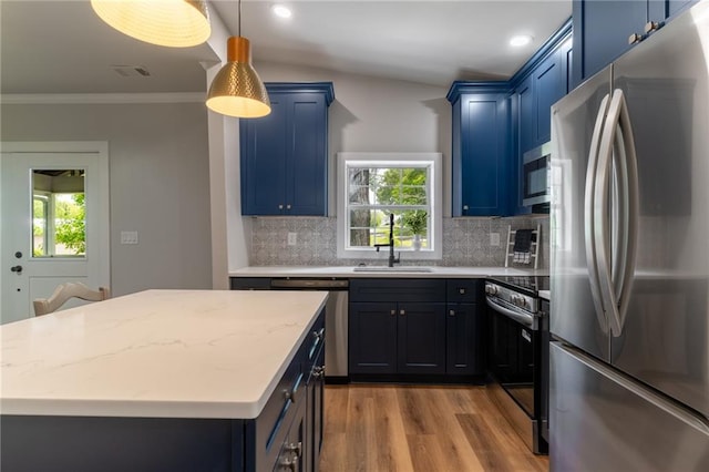 235 Lowry St, Ball Ground, GA 30107 - kitchen featuring appliances with stainless steel finishes, a sink, blue cabinets, ornamental molding, and wood finished floors
