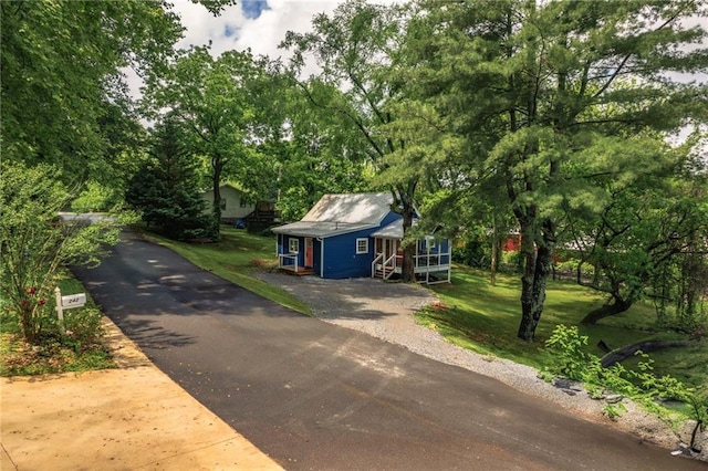 235 Lowry St, Ball Ground, GA 30107 - view of front of house featuring view of wooded area and a front lawn