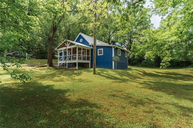 235 Lowry St, Ball Ground, GA 30107 - rear view of property with a sunroom, a yard, and metal roof