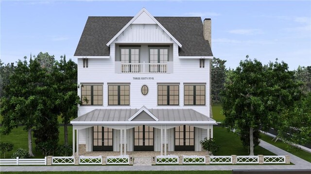 view of front of house with covered porch, a chimney, fence private yard, and a front yard