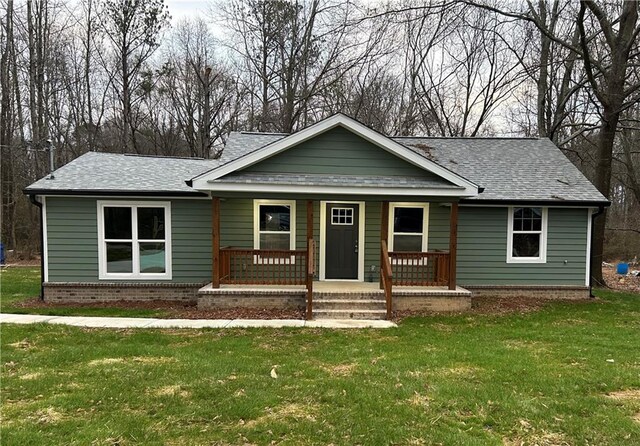 view of front of property with covered porch and a front yard