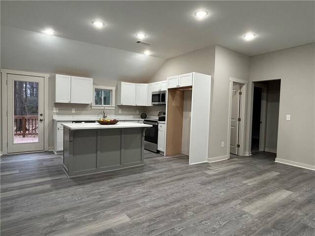 interior space with dark hardwood / wood-style flooring and lofted ceiling