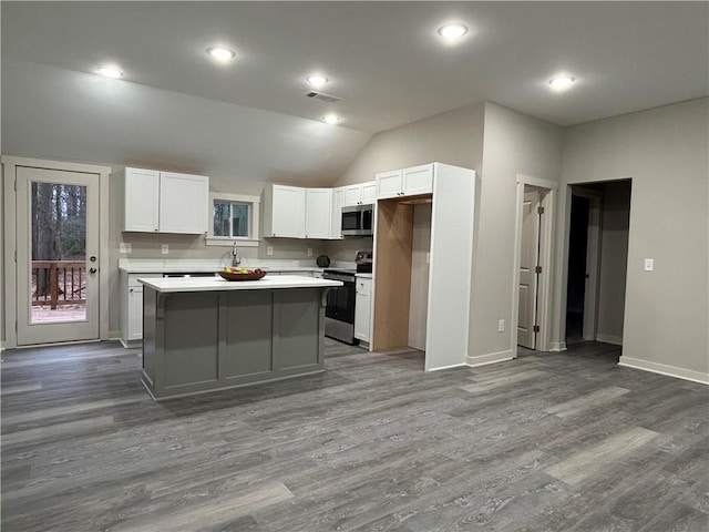 10033 Florence Cir, Villa Rica, GA 30180 - kitchen featuring dark wood-type flooring, appliances with stainless steel finishes, white cabinetry, and a center island