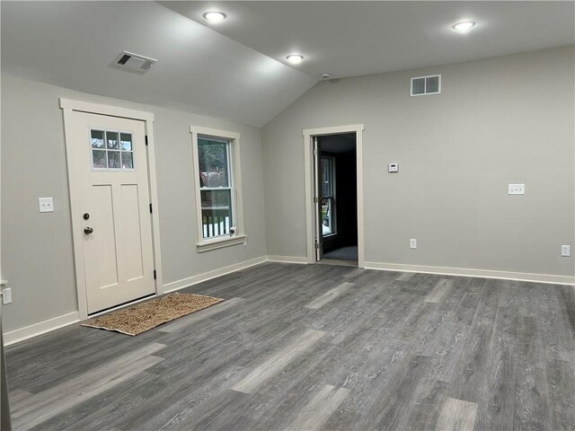 kitchen featuring white cabinetry, a center island, stainless steel appliances, and light stone counters