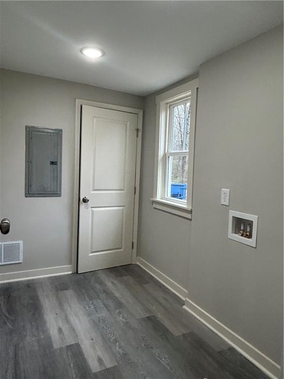 laundry room featuring washer hookup, dark hardwood / wood-style flooring, and electric panel