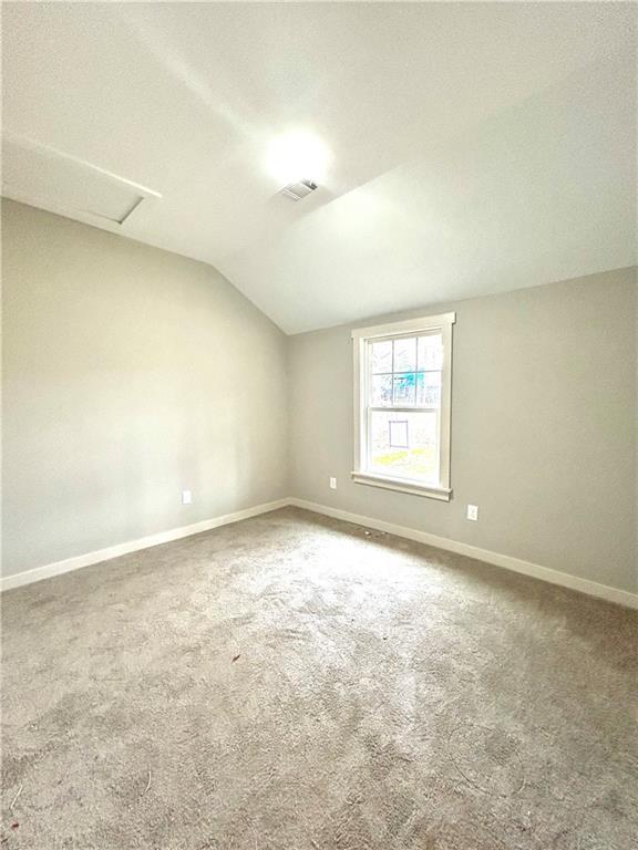 additional living space with carpet floors and lofted ceiling