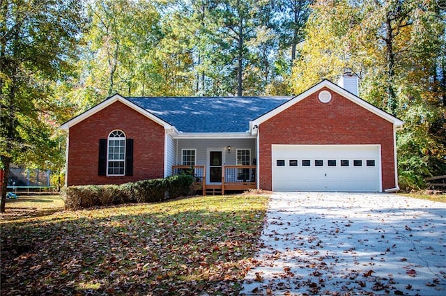 ranch-style home with a porch, a garage, and a trampoline