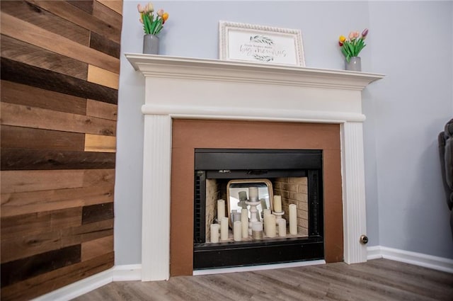 interior details with hardwood / wood-style floors and wooden walls