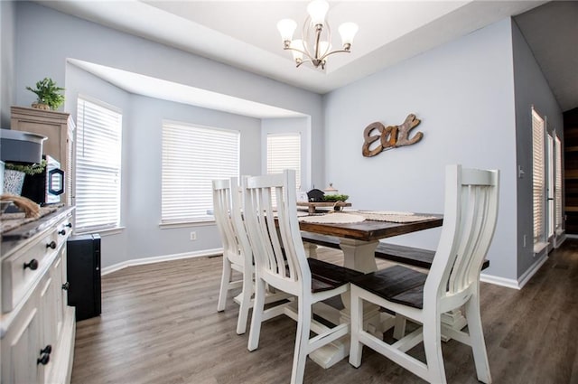 dining room with a notable chandelier and dark hardwood / wood-style floors