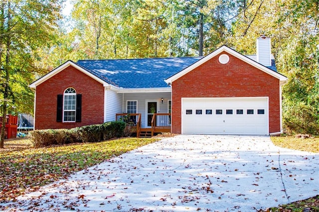 ranch-style house featuring a garage and covered porch